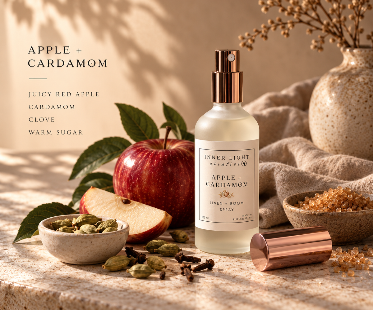 Apple + Cardamom Linen & Room Spray by Inner Light Creative styled with red apple and cardamom pods in warm natural light