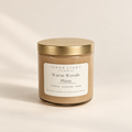 Inner Light Creative Warm Woods + Plum coconut soy candle in an oatmeal-colored glass jar with a gold lid and cream label.